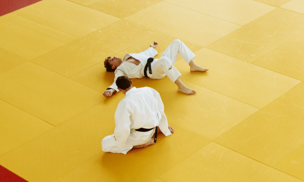 Two men who are fatigued after rolling, a common effect of overtraining.