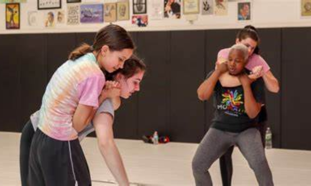 Students learning self-defense techniques.