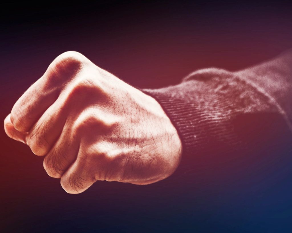 a clenched fist to remind people of danger in spite of bjj self-defense training