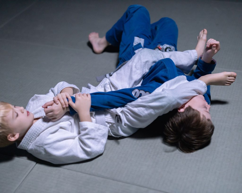 Two children practicing BJJ for self-defense.