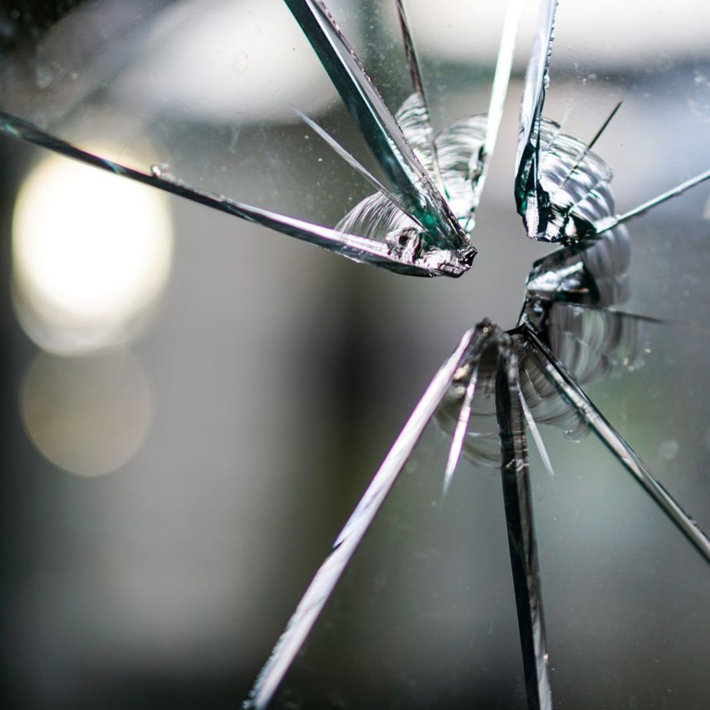 A window with broken glass, commonly associated with crime.