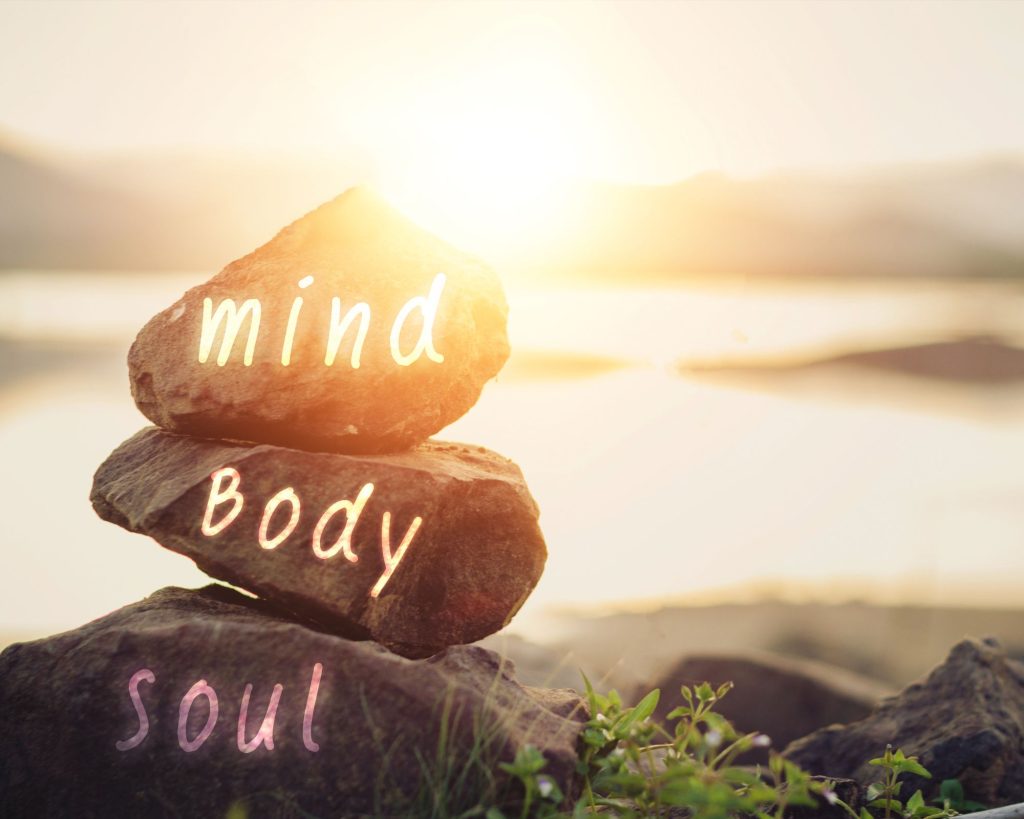 Rocks with the words, "mind," "body," and "soul" written on them.