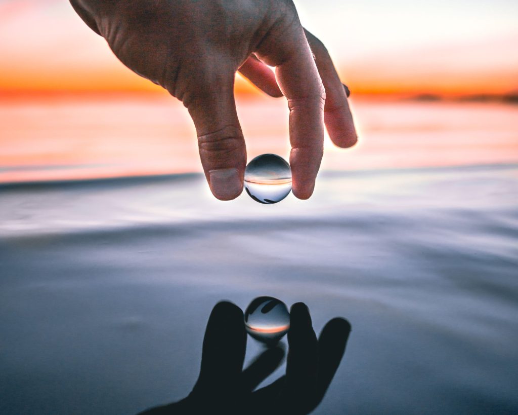 A drop of water perfectly held in someone's fingers, showing incredible balance.