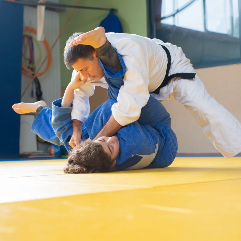 Two people practicing their grappling.
