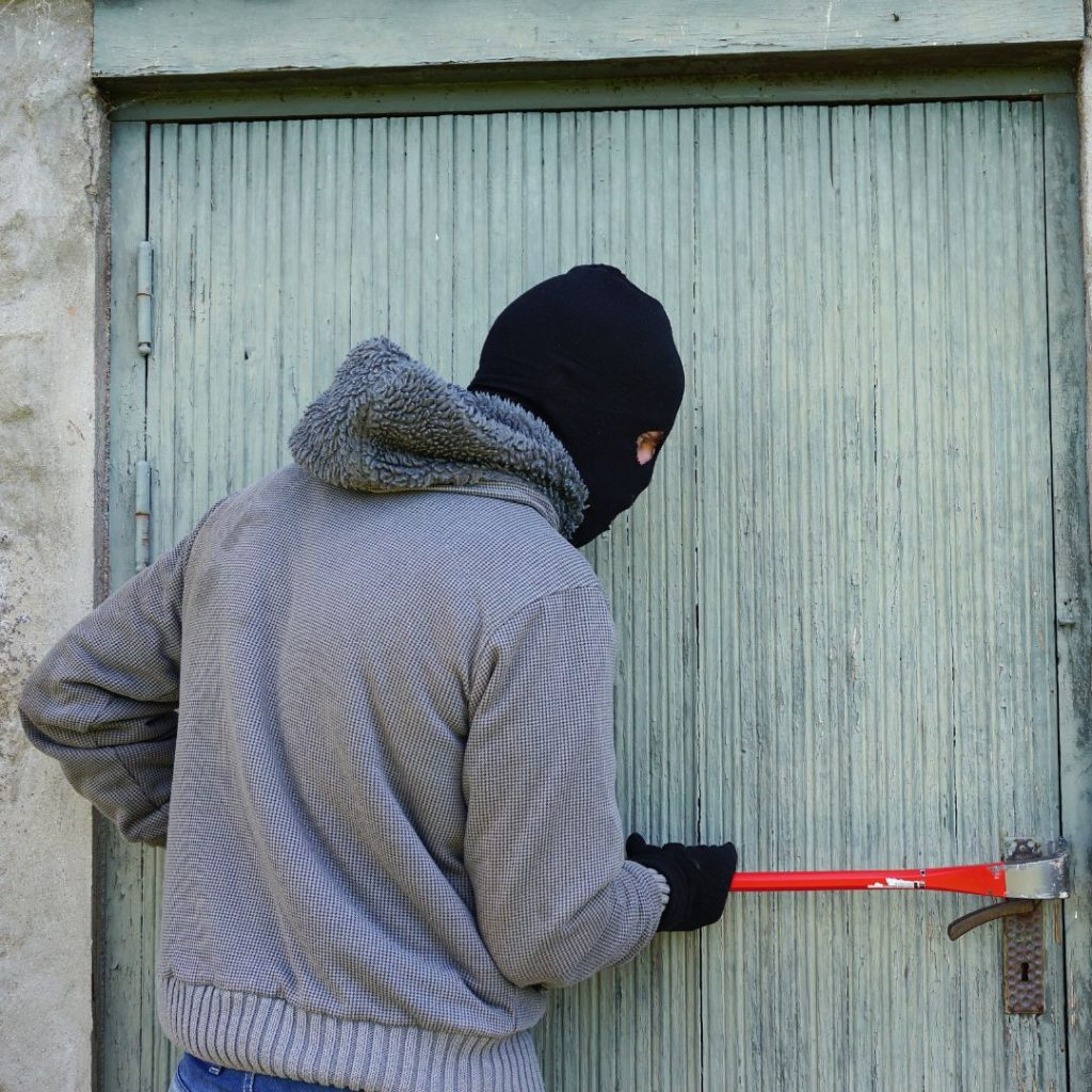 An intruder breaking into a home.