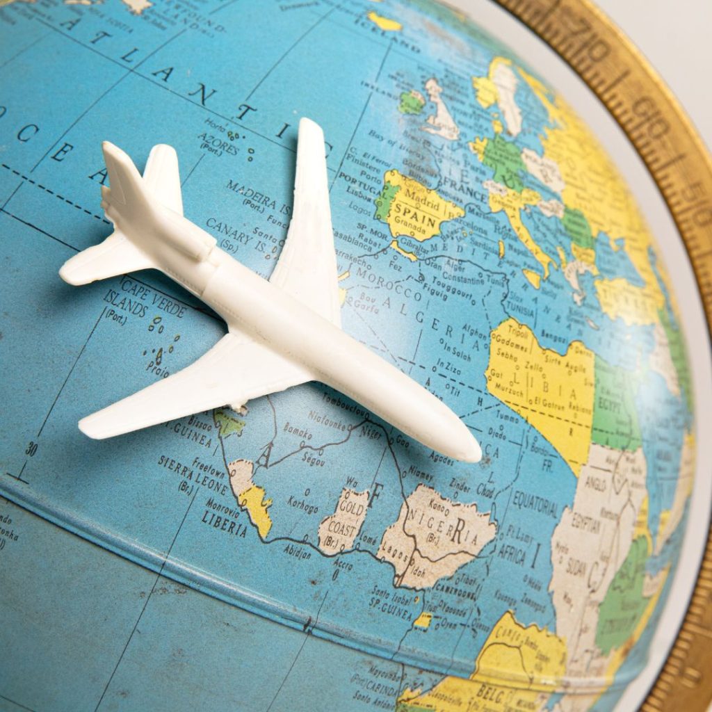 A toy airplane on a globe, indicating international travel.