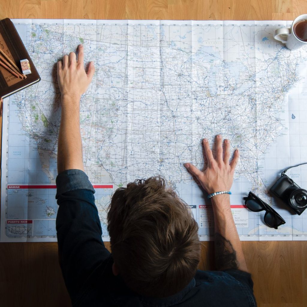 A person mapping out his travels, which is a good personal safety strategy to practice.