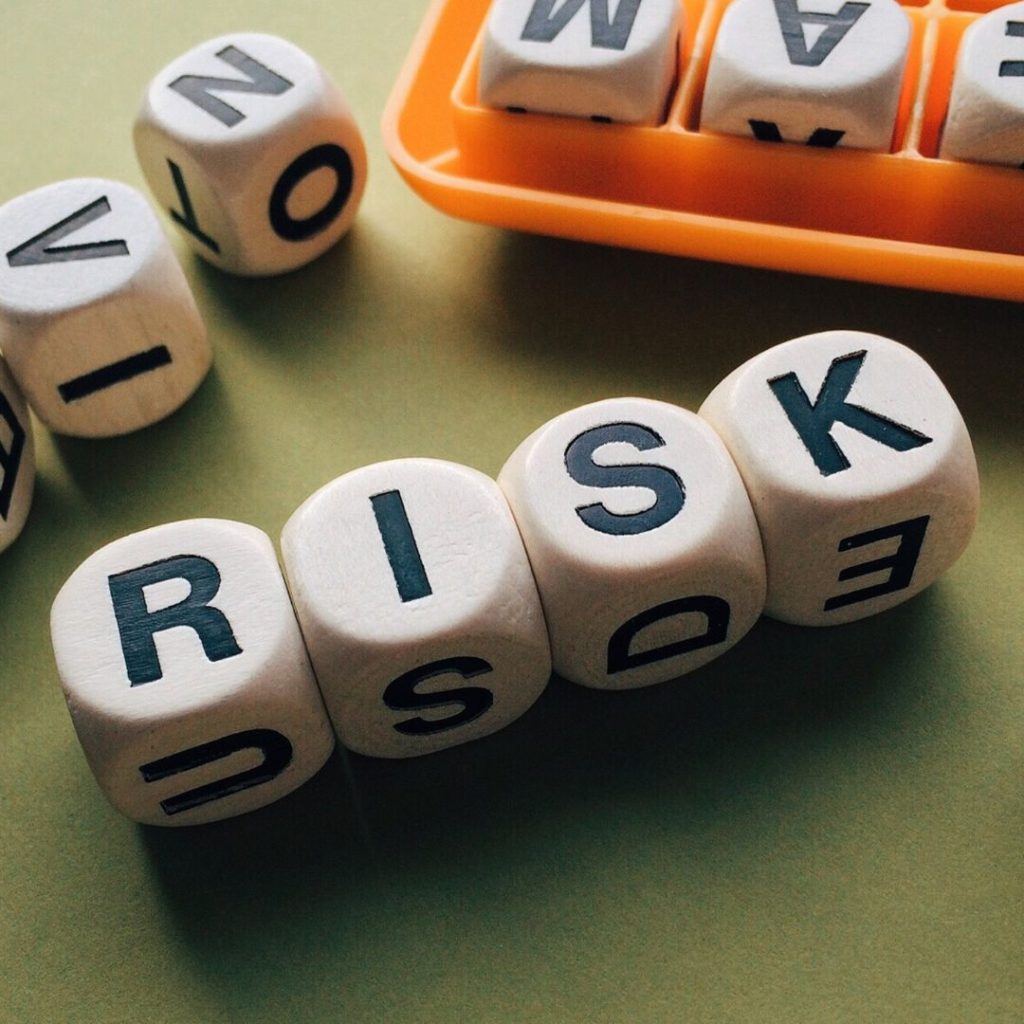 Cubes spelling out the word, "RISK."