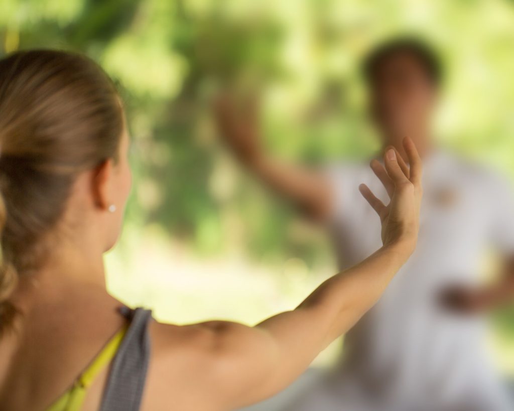 A woman using tai chi for mental wellness.