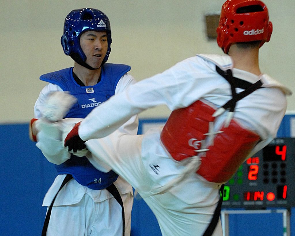 Two practitioners sparring in taekwondo.